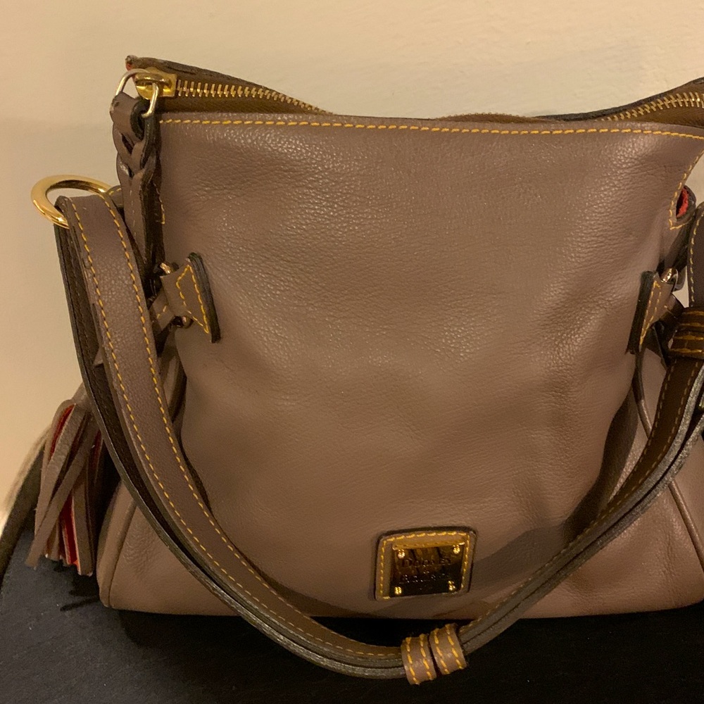 Dooney& Bourke genuine leather taupe bag with tassel
